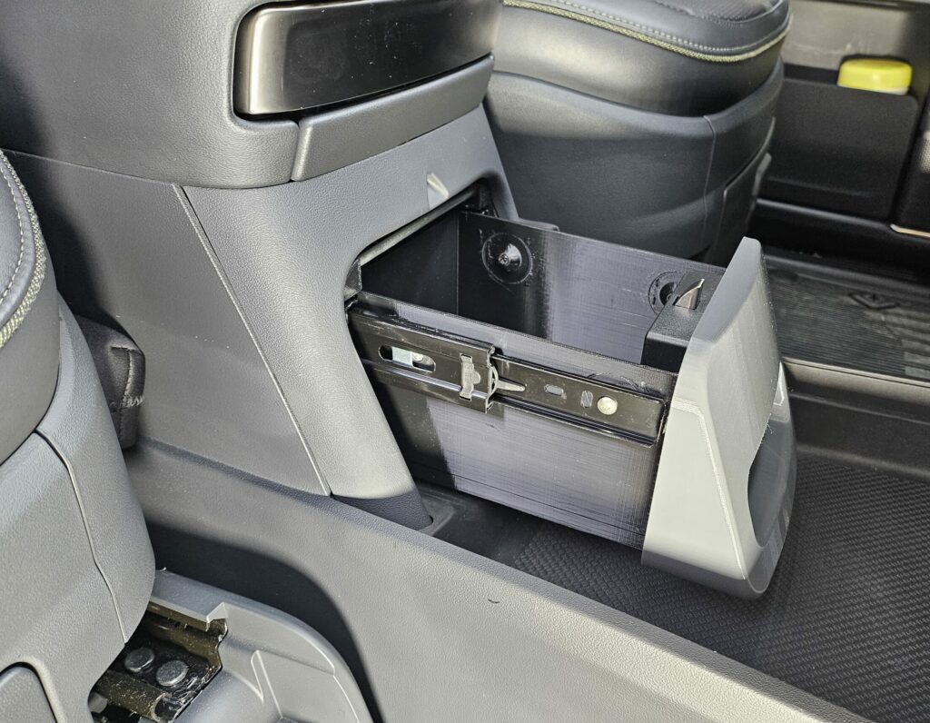 Photo shows RCS Safe installed in the Rivian center console cubby. The RCS Safe (stock version) is shown.