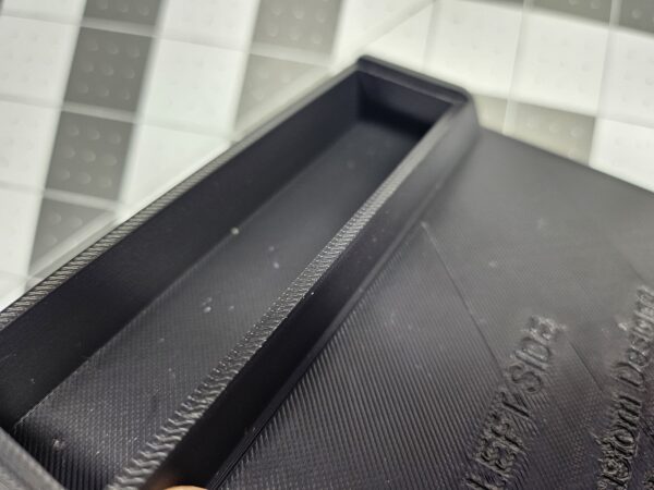 Closeup of a left-side unit license plate tool holder (LPTH), viewing the interior volume top.