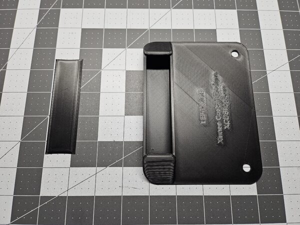 Closeup of a left-side unit license plate tool holder (LPTH) with the cover open.