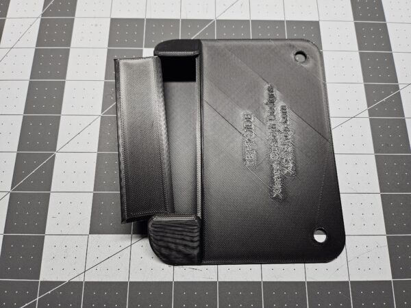 Closeup of a left-side unit license plate tool holder (LPTH) with the cover partially open.